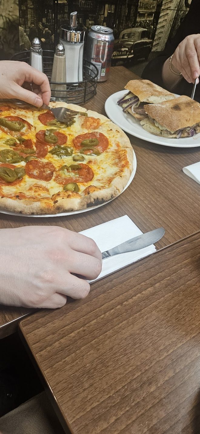 Pepperoni pizza with cutlery beside it
