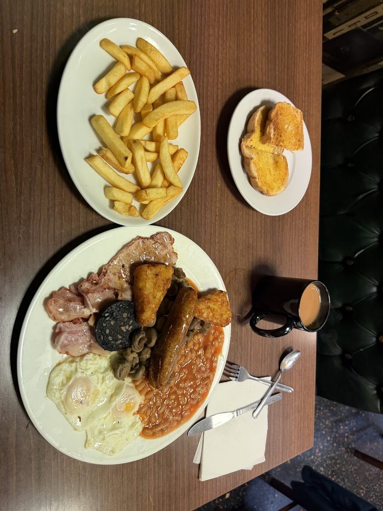 Full English breakfast: eggs, bacon, sausage, black pudding, beans and hash browns