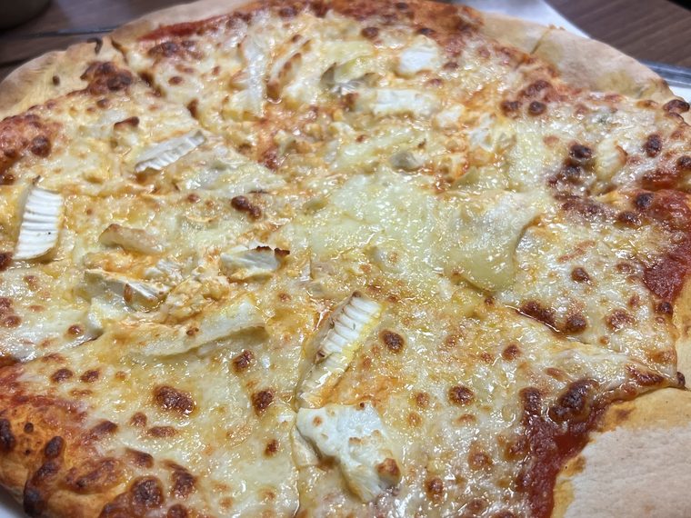 Pizza with melted cheese and brie